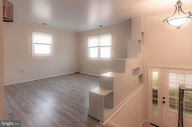 entryway featuring crown molding and light hardwood / wood-style flooring