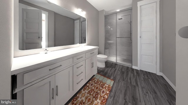 bathroom with a shower with door, vanity, hardwood / wood-style floors, and toilet