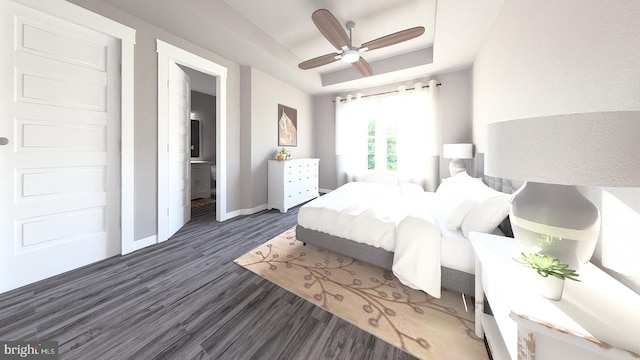 bedroom with a tray ceiling, ceiling fan, ensuite bathroom, and dark hardwood / wood-style floors