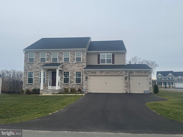 view of front facade with a garage and a front lawn