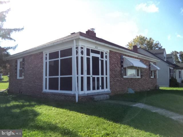 view of side of home featuring a lawn