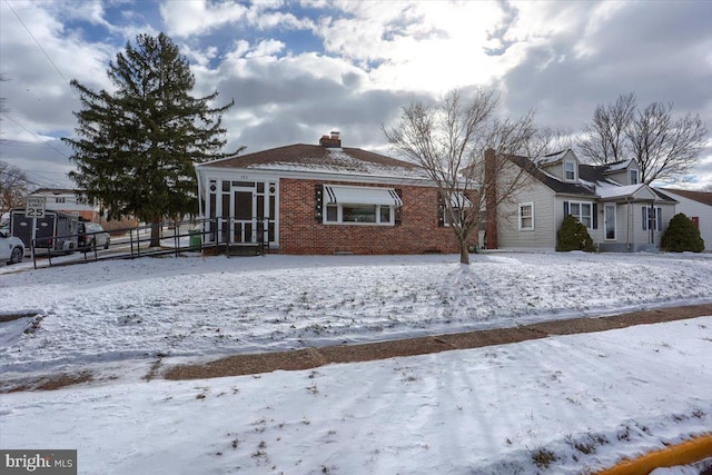 view of snow covered rear of property