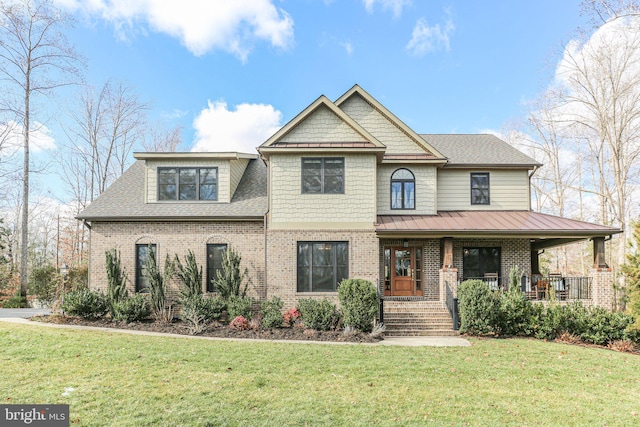 view of front of house with a porch and a front yard