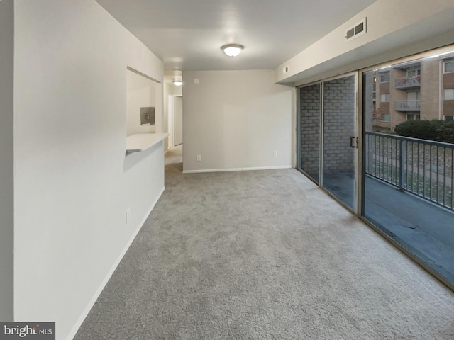 carpeted empty room featuring a fireplace