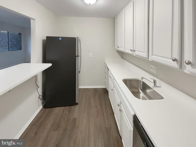 kitchen with dark hardwood / wood-style flooring, sink, white cabinets, and appliances with stainless steel finishes