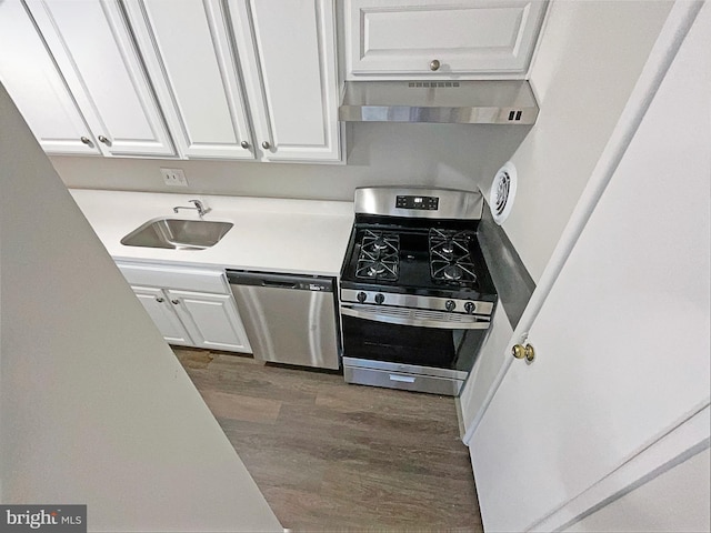 kitchen featuring white cabinetry, sink, extractor fan, and appliances with stainless steel finishes