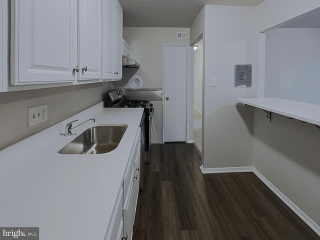 kitchen featuring white cabinets, dark hardwood / wood-style flooring, stainless steel electric stove, and sink