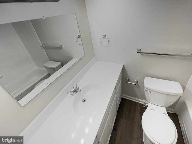 bathroom with vanity, hardwood / wood-style flooring, and toilet