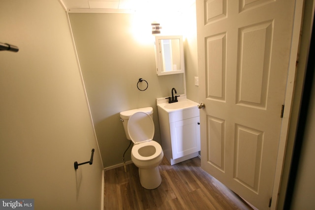 bathroom featuring hardwood / wood-style flooring, vanity, and toilet