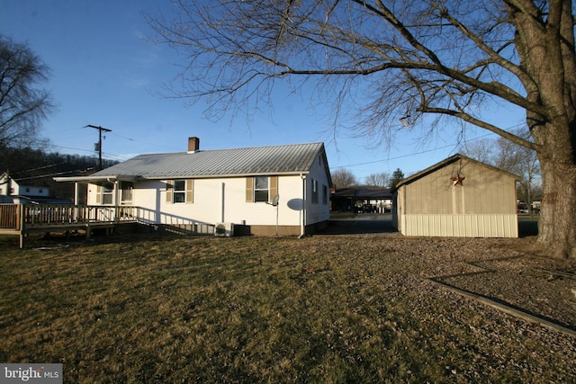 exterior space featuring a lawn and a deck