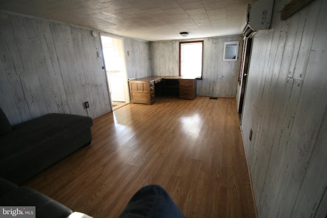 interior space with an AC wall unit and light hardwood / wood-style flooring