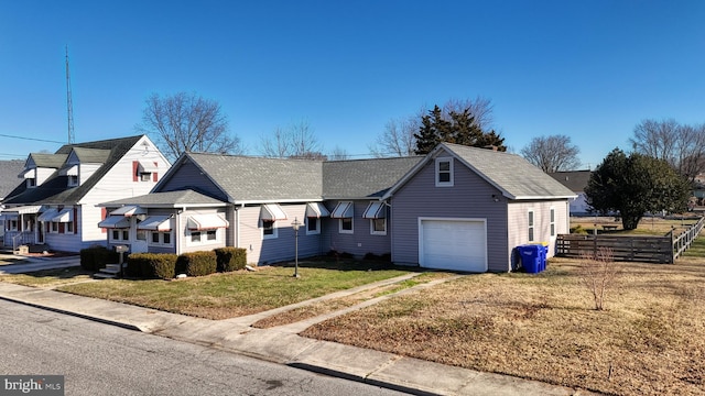 view of front of house with a garage and a front yard