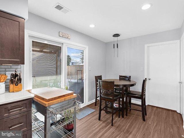 dining space with hardwood / wood-style flooring