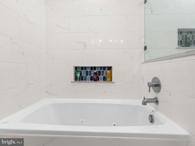 bathroom with a relaxing tiled tub