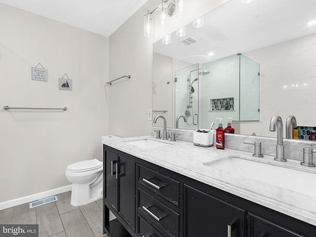 bathroom featuring vanity, toilet, and a shower with door