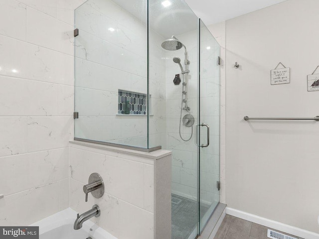 bathroom featuring a shower with door