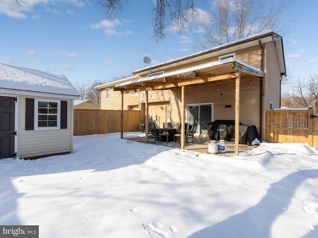 view of snow covered rear of property