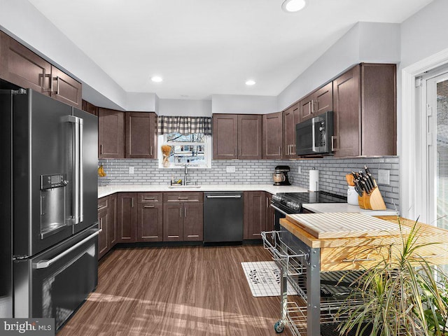 kitchen with tasteful backsplash, dark brown cabinetry, sink, and appliances with stainless steel finishes