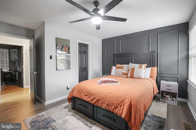 bedroom with ceiling fan and hardwood / wood-style flooring