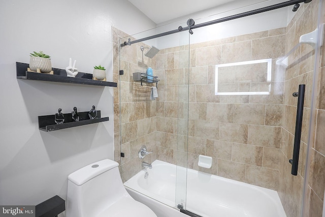 bathroom with toilet and combined bath / shower with glass door