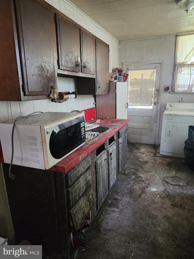 kitchen with dark brown cabinetry and washer / clothes dryer