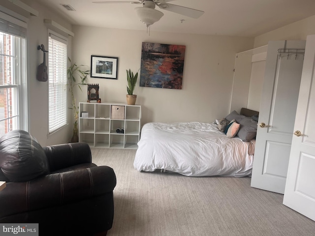 bedroom with light colored carpet and ceiling fan