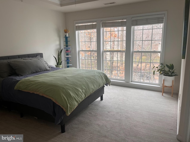 carpeted bedroom featuring crown molding