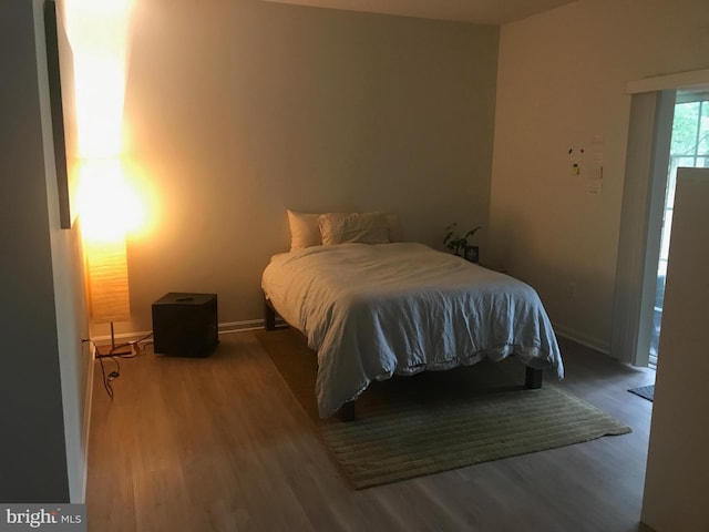 bedroom with hardwood / wood-style flooring