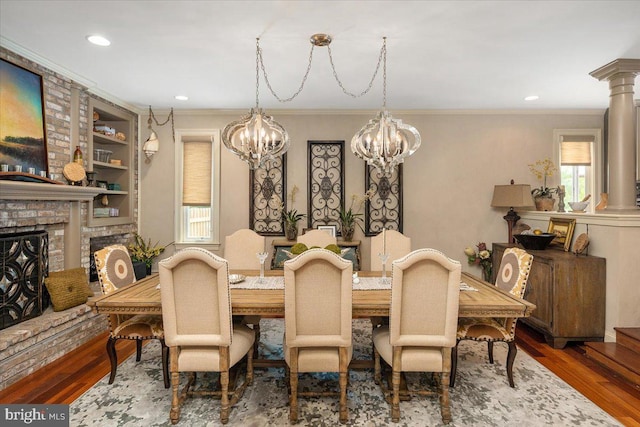 dining area featuring decorative columns, dark hardwood / wood-style flooring, crown molding, and built in features