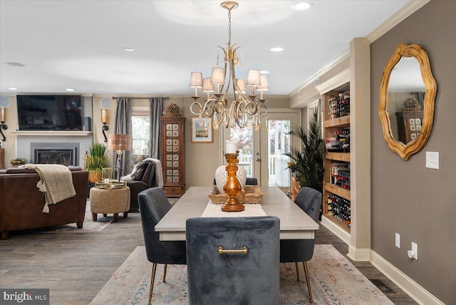 dining space featuring dark hardwood / wood-style floors, ornamental molding, a wealth of natural light, and french doors