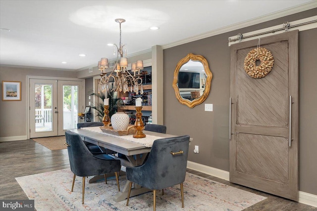 dining area with french doors, an inviting chandelier, wood-type flooring, and ornamental molding