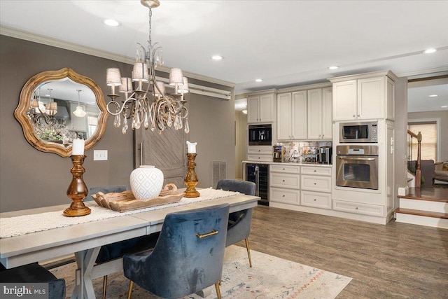 kitchen with hanging light fixtures, hardwood / wood-style flooring, tasteful backsplash, stainless steel appliances, and beverage cooler