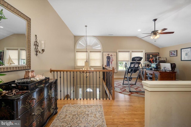 hall featuring light hardwood / wood-style flooring and lofted ceiling