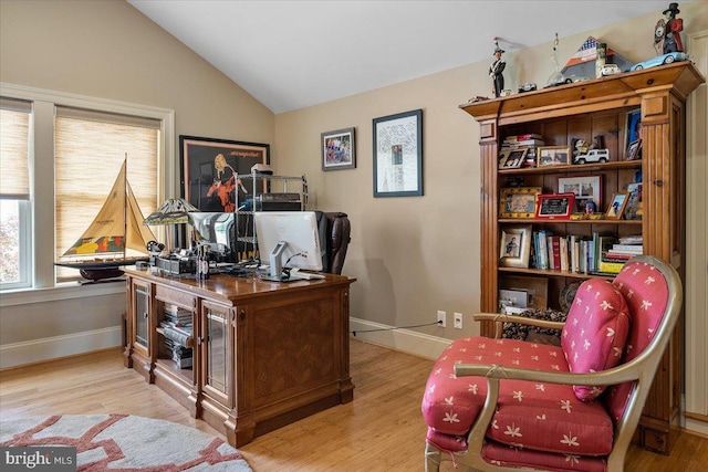 office space with lofted ceiling and light hardwood / wood-style flooring