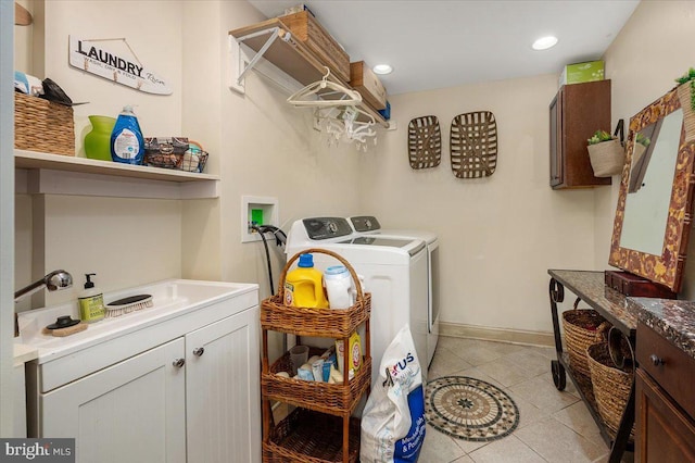 laundry room with washer and dryer, sink, light tile patterned floors, and cabinets