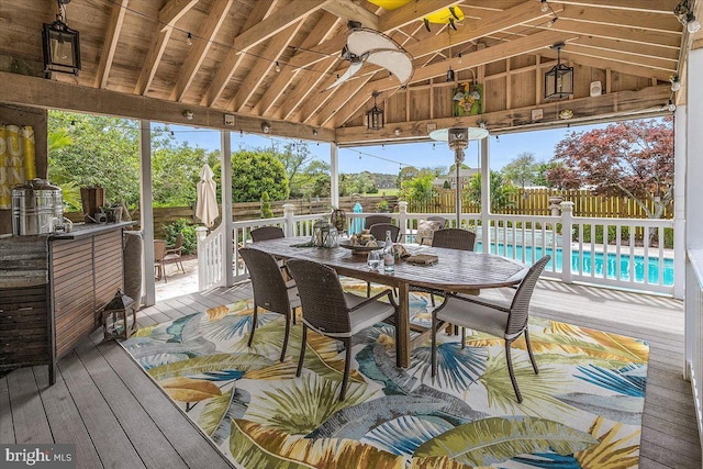 sunroom featuring vaulted ceiling