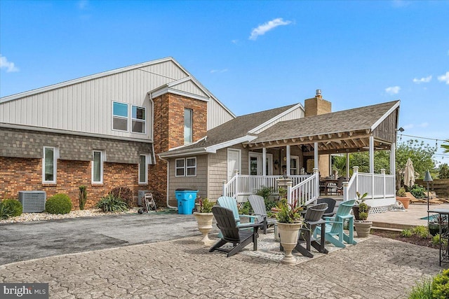 rear view of property featuring central AC unit