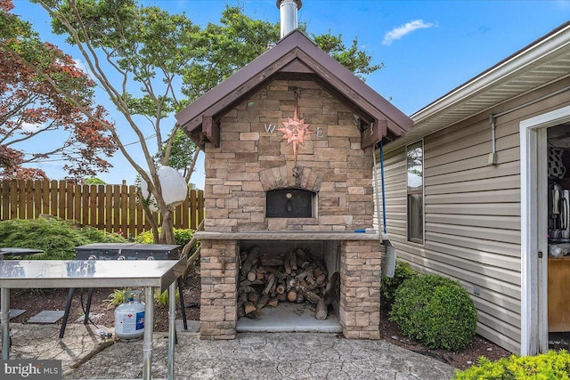 view of patio / terrace with an outdoor stone fireplace