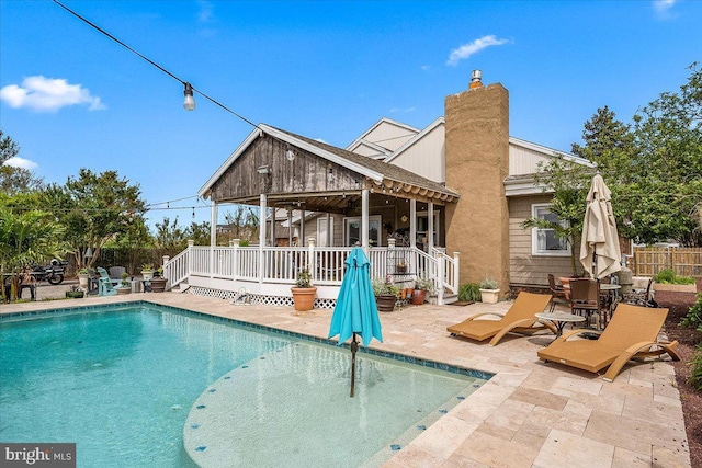 view of pool with a patio area and a deck