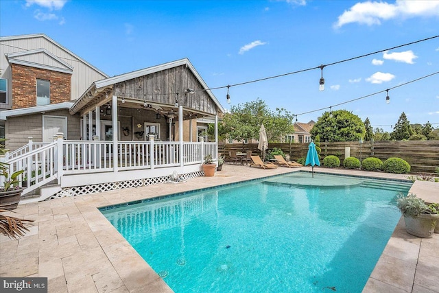 view of pool with ceiling fan and a patio