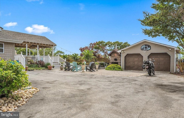 view of yard featuring covered porch and a garage