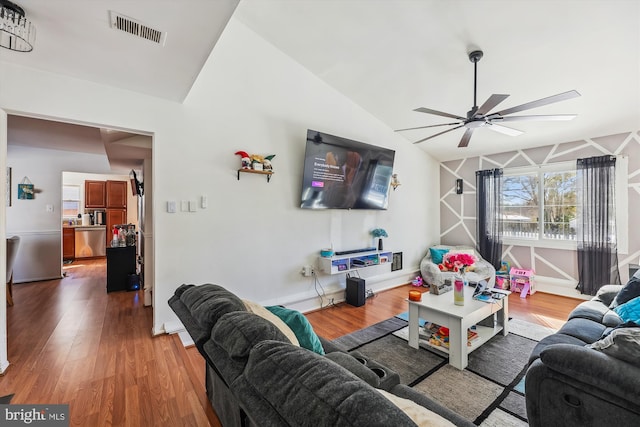 living room featuring lofted ceiling, hardwood / wood-style flooring, and ceiling fan