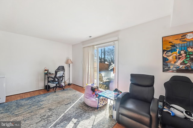 sitting room with hardwood / wood-style flooring