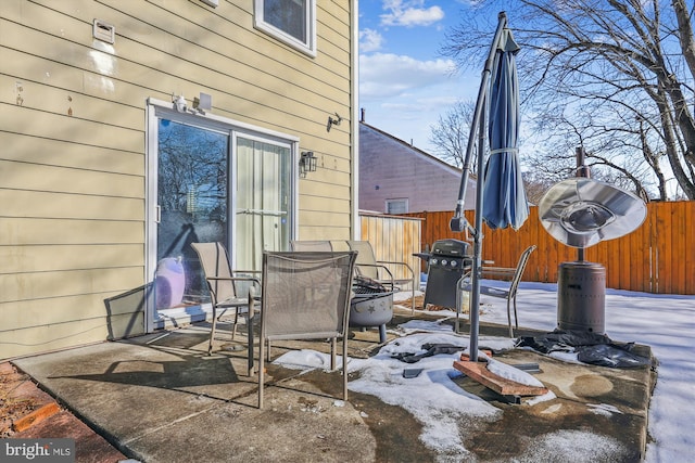 snow covered patio featuring area for grilling