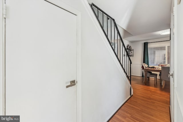 stairs featuring hardwood / wood-style flooring