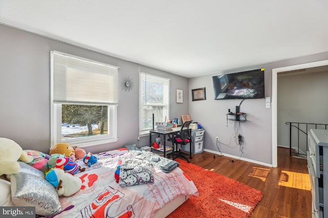 bedroom with dark hardwood / wood-style floors