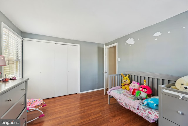 bedroom with a closet and dark hardwood / wood-style floors