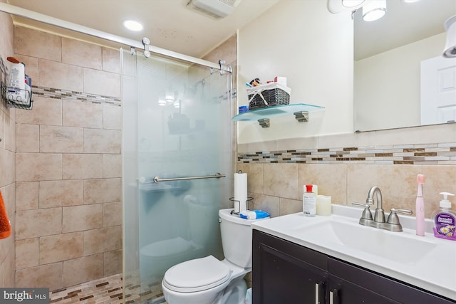 bathroom featuring toilet, an enclosed shower, vanity, and tile walls