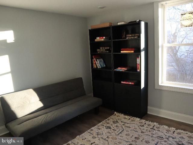 sitting room with dark hardwood / wood-style flooring