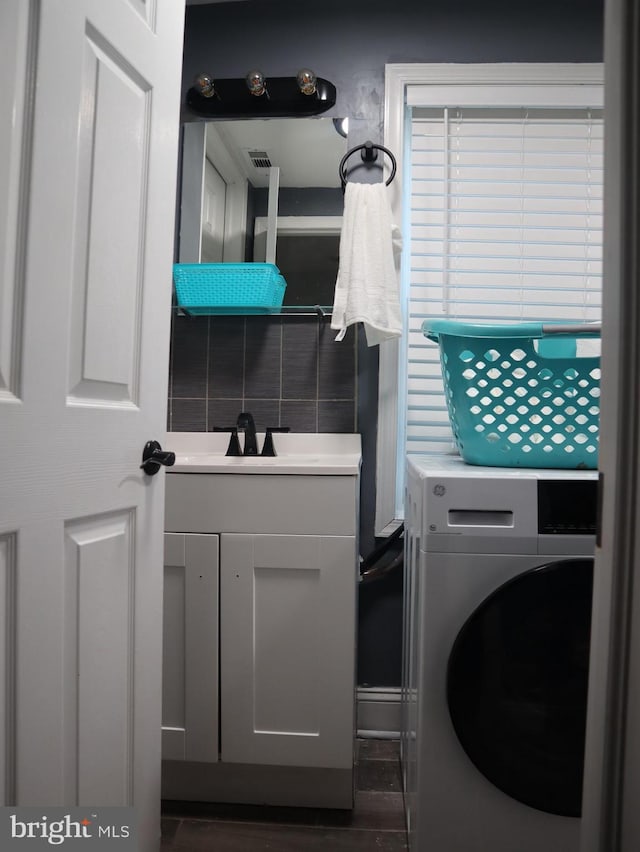 washroom with washer / clothes dryer and sink